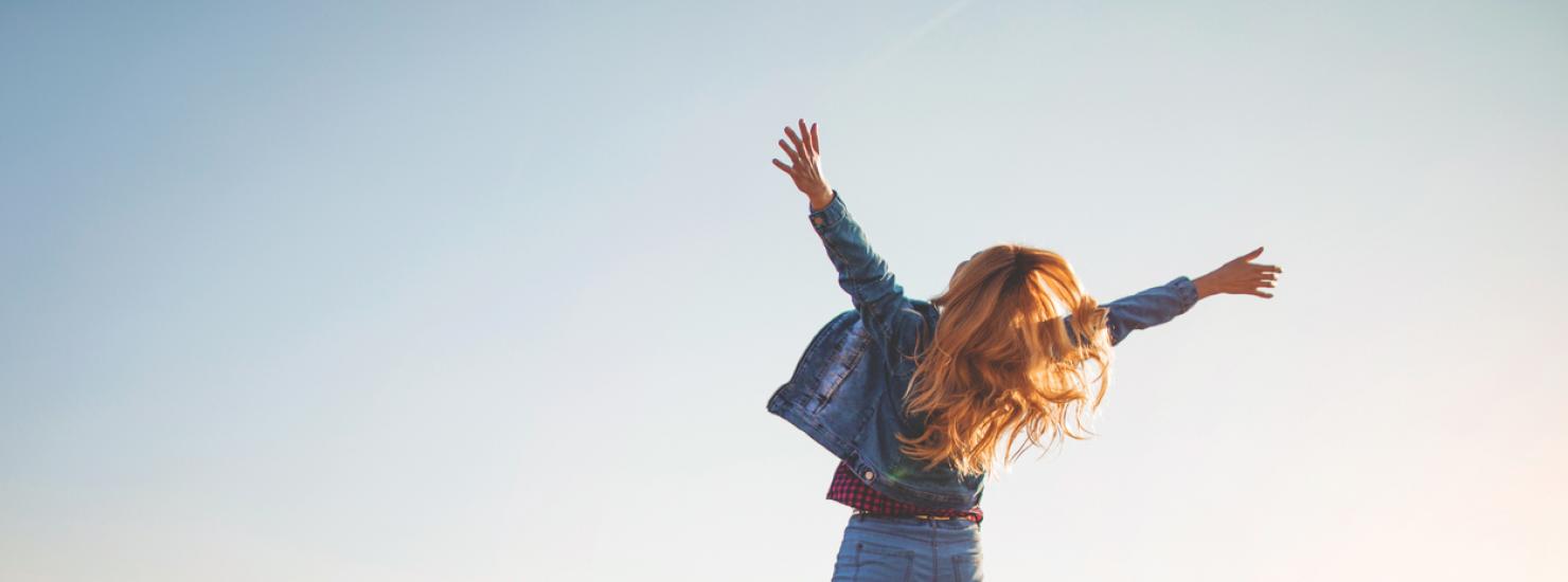 A happy woman is jumping
