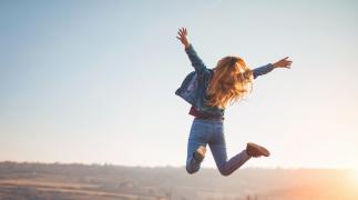 A happy woman is jumping 